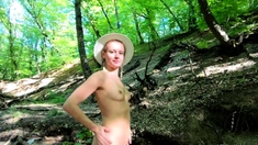 Nudist girl walks in the woods