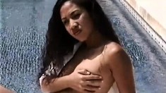 Seductive Asian girl Noy reveals the contours of her body by the pool